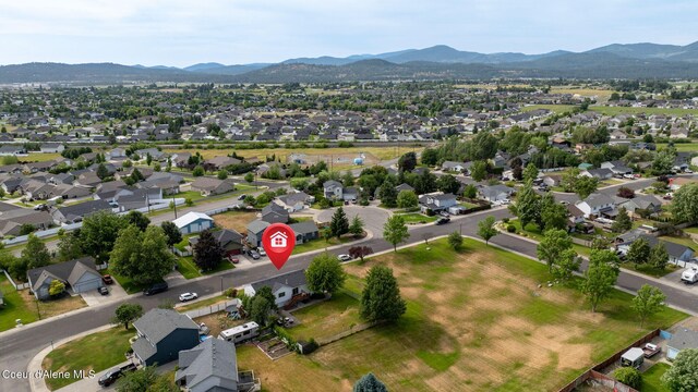2442 N Rawhide Ridge Rd, Post Falls, ID 83854 - aerial view of property and surrounding area featuring mountains and nearby suburban area