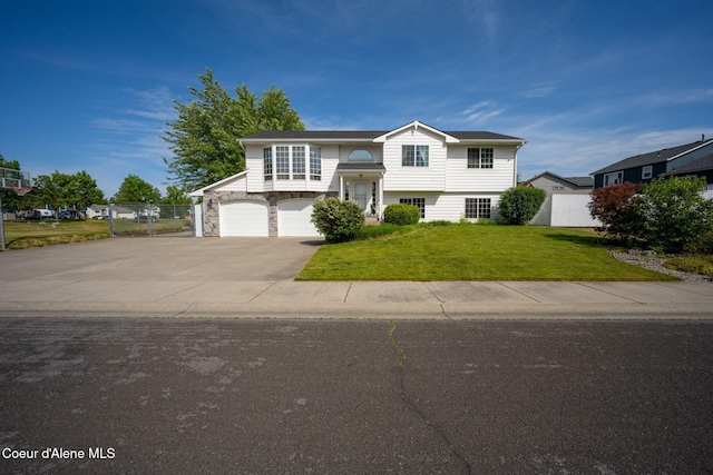 2442 N Rawhide Ridge Rd, Post Falls, ID 83854 - split foyer home featuring an attached garage, concrete driveway, and stone siding