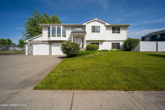 2442 N Rawhide Ridge Rd, Post Falls, ID 83854 - raised ranch featuring an attached garage, driveway, and stone siding
