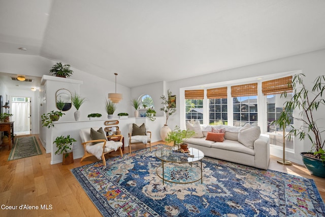 2442 N Rawhide Ridge Rd, Post Falls, ID 83854 - living area featuring wood finished floors, vaulted ceiling, and plenty of natural light