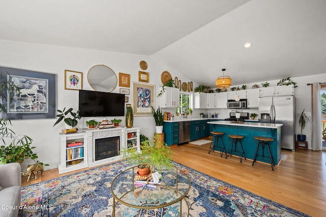 2442 N Rawhide Ridge Rd, Post Falls, ID 83854 - living area with vaulted ceiling, light wood-type flooring, and recessed lighting