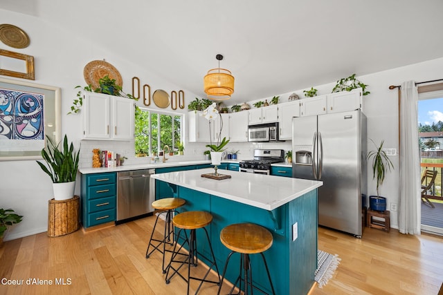 2442 N Rawhide Ridge Rd, Post Falls, ID 83854 - kitchen featuring stainless steel appliances, light wood finished floors, and backsplash