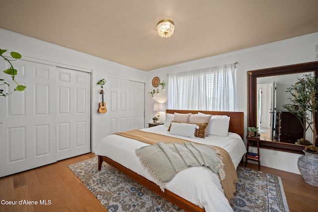 2442 N Rawhide Ridge Rd, Post Falls, ID 83854 - bedroom with two closets, wood finished floors, and ornamental molding