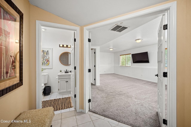 2442 N Rawhide Ridge Rd, Post Falls, ID 83854 - hall featuring light tile patterned flooring, light colored carpet, and lofted ceiling