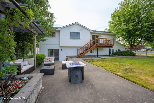 2442 N Rawhide Ridge Rd, Post Falls, ID 83854 - rear view of house featuring an outdoor living space with a fire pit, stairs, a lawn, a patio, and a deck