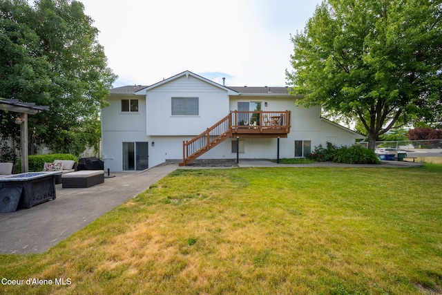 2442 N Rawhide Ridge Rd, Post Falls, ID 83854 - rear view of house featuring stairs, a wooden deck, a fire pit, and a patio