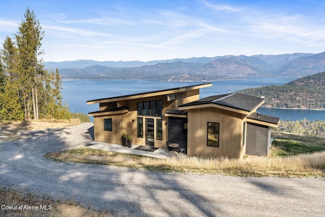 1376 Less Traveled Rd, Sagle, ID 83860 - view of front of home featuring a water and mountain view and a patio