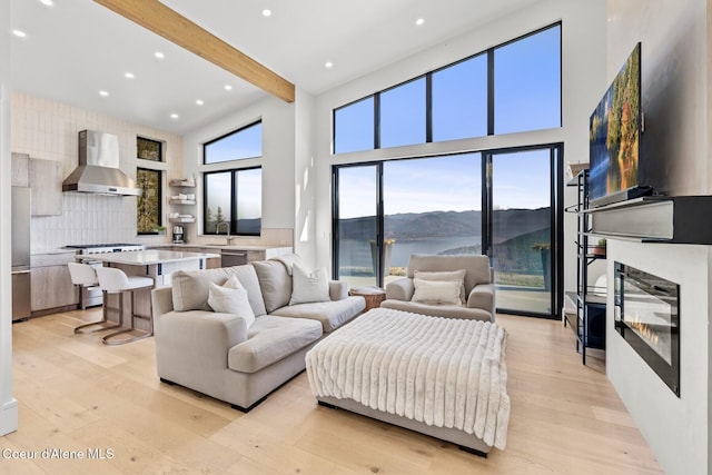 1376 Less Traveled Rd, Sagle, ID 83860 - living room with beam ceiling, light wood-type flooring, a high ceiling, and recessed lighting