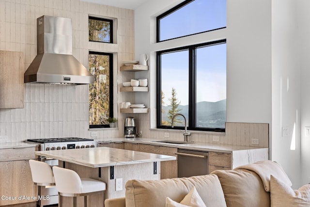 1376 Less Traveled Rd, Sagle, ID 83860 - kitchen featuring wall chimney range hood, stainless steel dishwasher, open floor plan, and backsplash