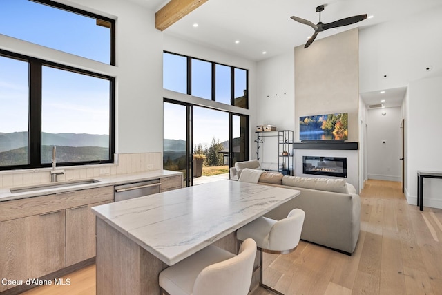1376 Less Traveled Rd, Sagle, ID 83860 - kitchen with a high ceiling, modern cabinets, dishwasher, a kitchen island, and light wood finished floors