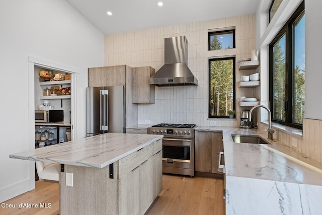 1376 Less Traveled Rd, Sagle, ID 83860 - kitchen featuring wall chimney range hood, high end appliances, modern cabinets, open shelves, and light stone countertops