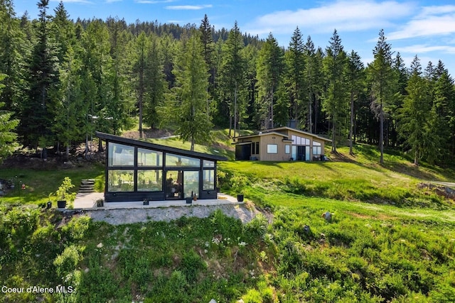 1376 Less Traveled Rd, Sagle, ID 83860 - back of property featuring a forest view and a sunroom