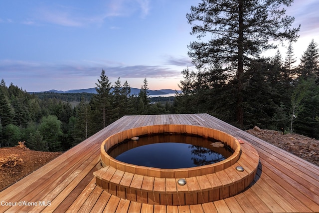 5 Crystal Springs Ct, Sandpoint, ID 83864 - deck featuring a wooded view, a jacuzzi, and a mountain view