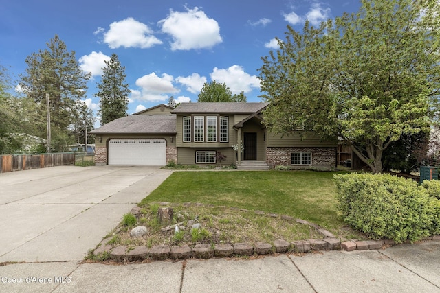 405 W 22nd Ave, Post Falls, ID 83854 - bi-level home with brick siding, a garage, and driveway
