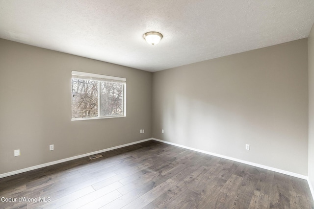 405 W 22nd Ave, Post Falls, ID 83854 - unfurnished room featuring dark wood-style floors and a textured ceiling