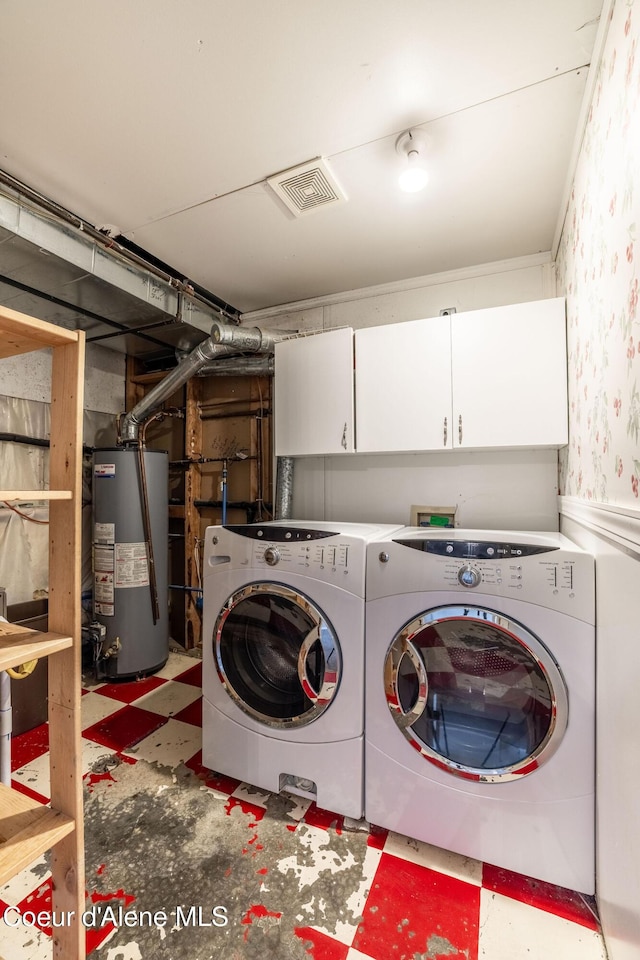 405 W 22nd Ave, Post Falls, ID 83854 - laundry area featuring gas water heater, washer and clothes dryer, tile patterned floors, cabinet space, and wallpapered walls