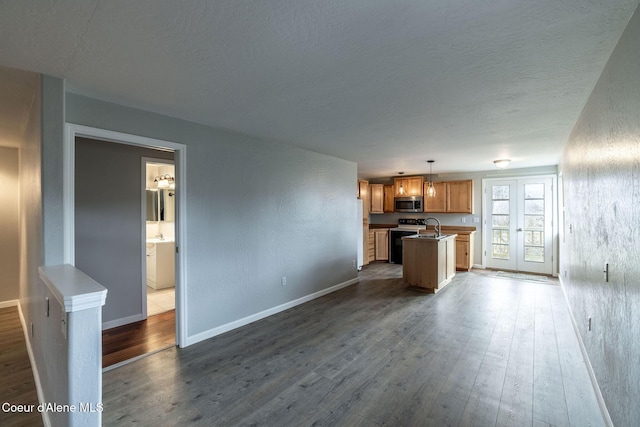 405 W 22nd Ave, Post Falls, ID 83854 - unfurnished living room featuring dark wood-type flooring and a textured ceiling