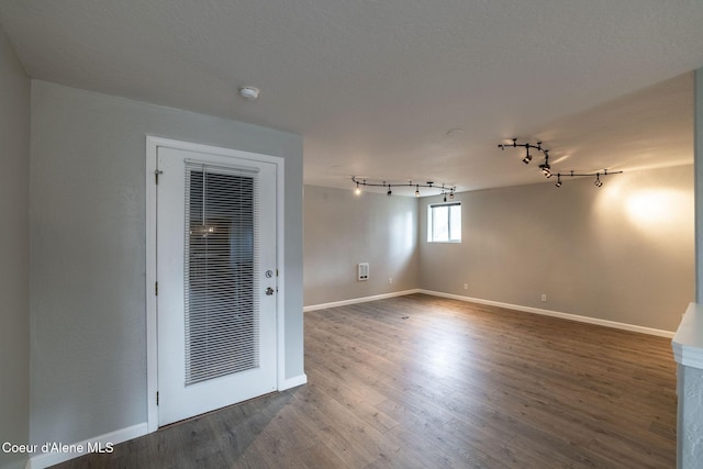 405 W 22nd Ave, Post Falls, ID 83854 - empty room featuring a smoke detector, wood finished floors, and rail lighting