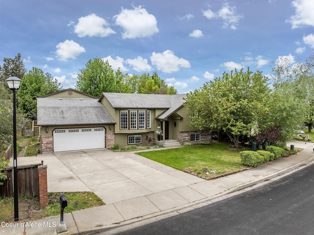 405 W 22nd Ave, Post Falls, ID 83854 - view of front of house featuring brick siding, an attached garage, concrete driveway, and roof with shingles