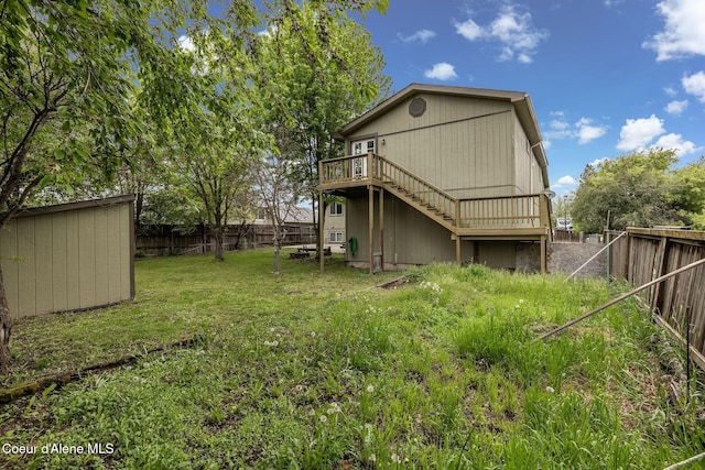 405 W 22nd Ave, Post Falls, ID 83854 - rear view of house featuring a fenced backyard, stairway, a deck, and a storage shed