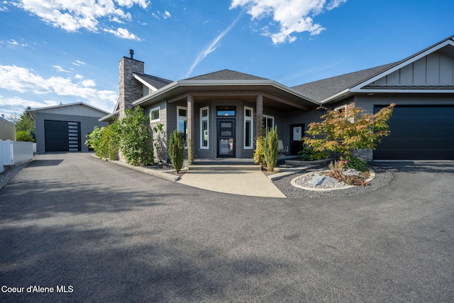 1222 W Tamarindo Ln, Hayden, ID 83835 - view of front of property featuring a chimney, board and batten siding, and a porch