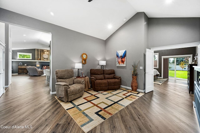 1222 W Tamarindo Ln, Hayden, ID 83835 - living room featuring vaulted ceiling, a warm lit fireplace, wood finished floors, plenty of natural light, and recessed lighting
