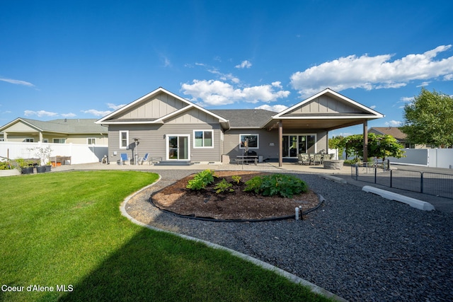 1222 W Tamarindo Ln, Hayden, ID 83835 - back of house with board and batten siding, a fenced backyard, and a patio