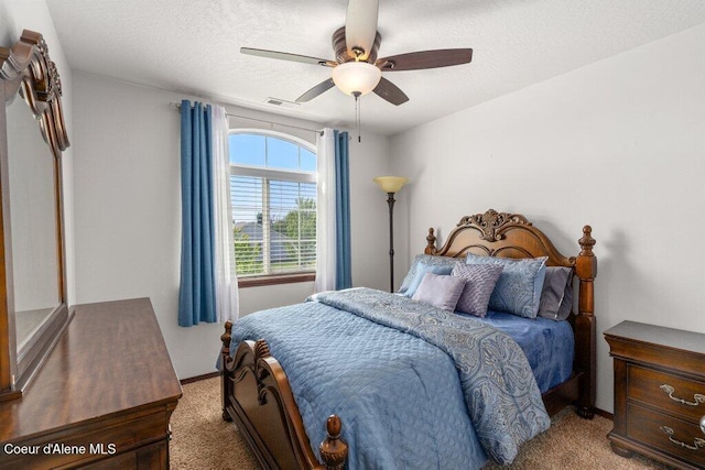 7090 N Epervier Ln, Coeur Dalene, ID 83815 - bedroom with carpet, a ceiling fan, and a textured ceiling