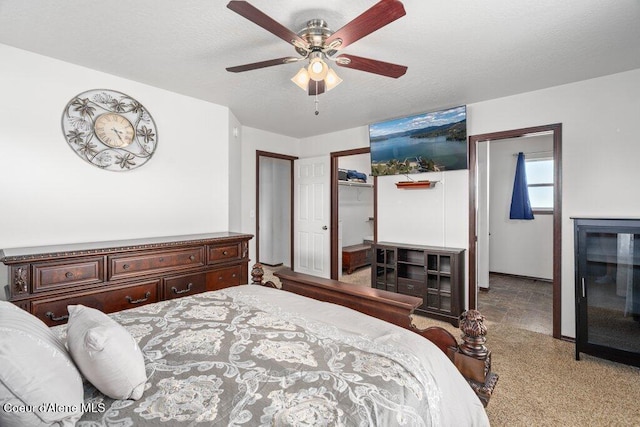 7090 N Epervier Ln, Coeur Dalene, ID 83815 - carpeted bedroom featuring a walk in closet and ceiling fan