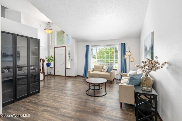 7090 N Epervier Ln, Coeur Dalene, ID 83815 - living area featuring dark wood-style flooring, vaulted ceiling, and a textured ceiling