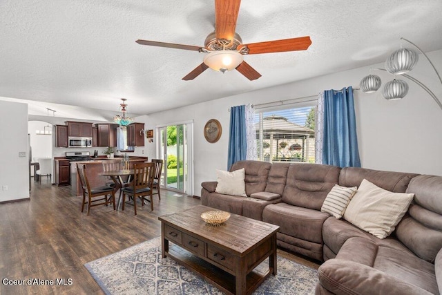 7090 N Epervier Ln, Coeur Dalene, ID 83815 - living room with a textured ceiling, ceiling fan, and dark wood-style flooring