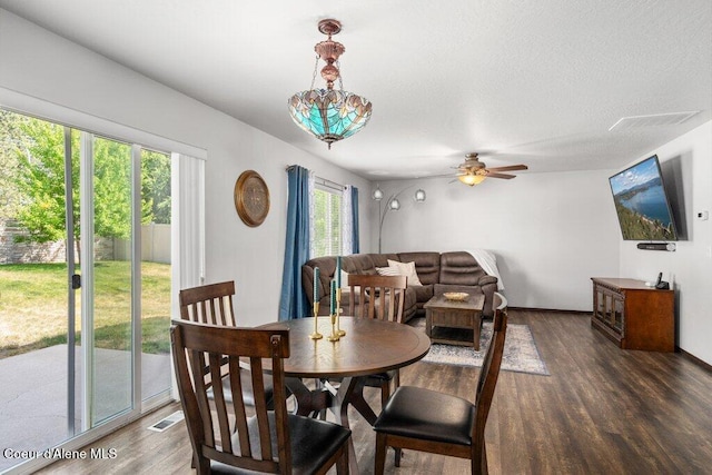 7090 N Epervier Ln, Coeur Dalene, ID 83815 - dining space with wood finished floors, a ceiling fan, and a textured ceiling