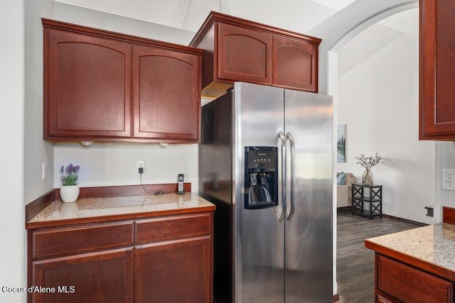 7090 N Epervier Ln, Coeur Dalene, ID 83815 - kitchen featuring stainless steel fridge with ice dispenser, dark wood-style floors, light countertops, and arched walkways