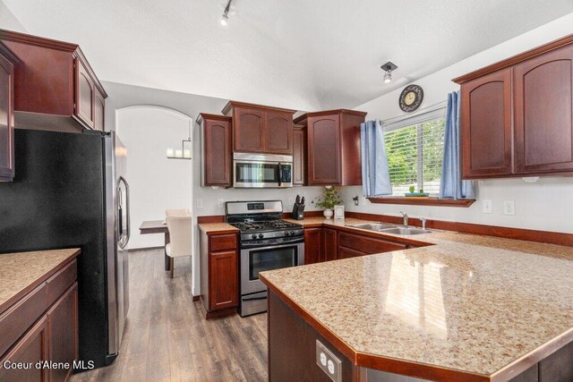 7090 N Epervier Ln, Coeur Dalene, ID 83815 - kitchen featuring stainless steel appliances, a peninsula, dark wood-type flooring, and light countertops