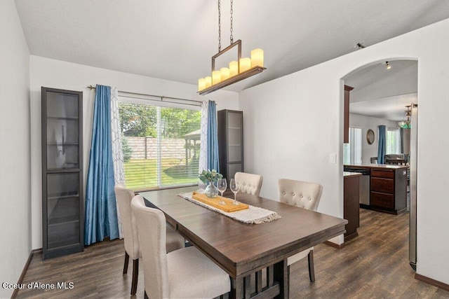 7090 N Epervier Ln, Coeur Dalene, ID 83815 - dining space featuring arched walkways and dark wood finished floors