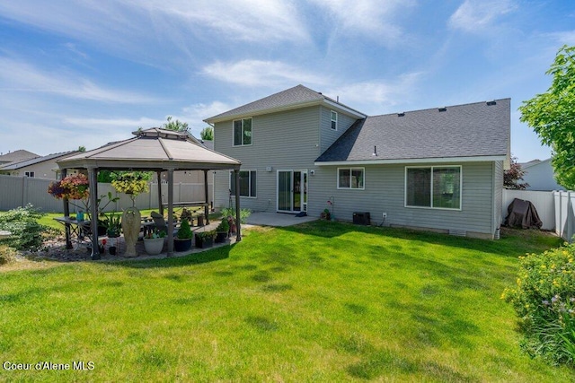 7090 N Epervier Ln, Coeur Dalene, ID 83815 - back of property featuring a gazebo, a fenced backyard, a patio area, and a shingled roof