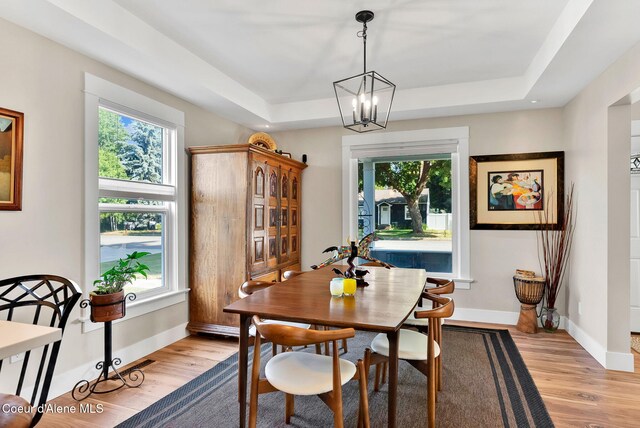 310 W Linden Ave, Coeur Dalene, ID 83814 - dining space with a tray ceiling, light wood-style floors, and a chandelier