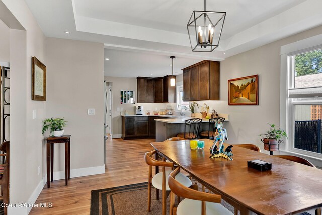 310 W Linden Ave, Coeur Dalene, ID 83814 - dining space with a raised ceiling, light wood finished floors, recessed lighting, and a chandelier