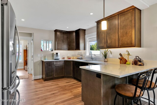 310 W Linden Ave, Coeur Dalene, ID 83814 - kitchen featuring freestanding refrigerator, a peninsula, light wood-style floors, light countertops, and recessed lighting