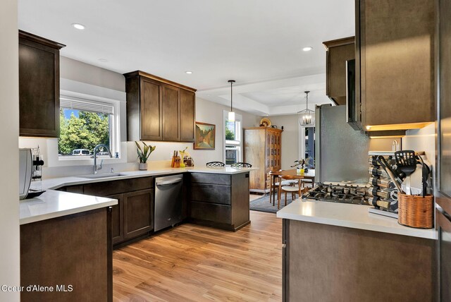 310 W Linden Ave, Coeur Dalene, ID 83814 - kitchen with appliances with stainless steel finishes, dark brown cabinets, light wood-style floors, light countertops, and recessed lighting