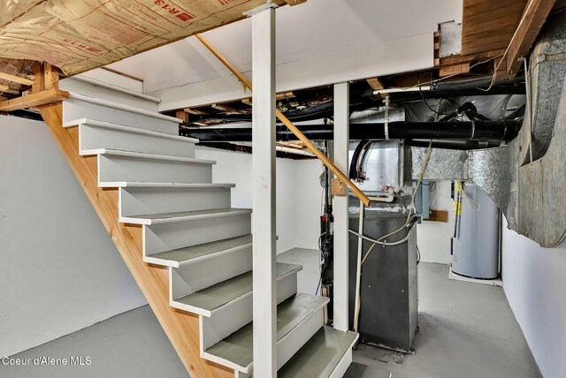 310 W Linden Ave, Coeur Dalene, ID 83814 - below grade area featuring water heater, stairs, and heating unit