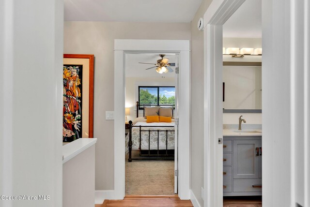 310 W Linden Ave, Coeur Dalene, ID 83814 - hallway with wood finished floors and a sink