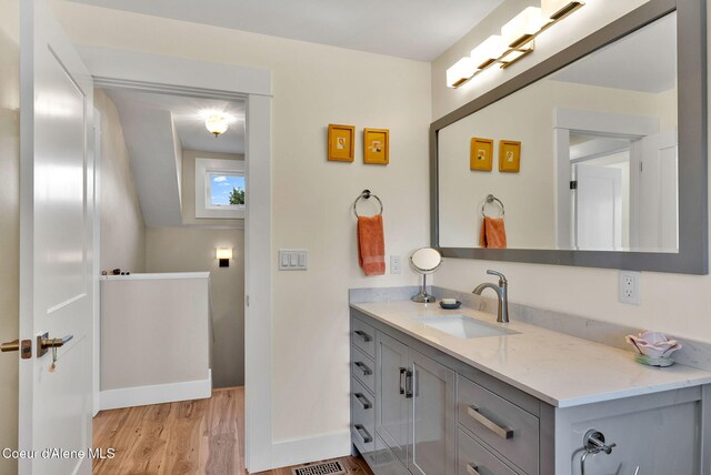 310 W Linden Ave, Coeur Dalene, ID 83814 - bathroom featuring wood finished floors and vanity
