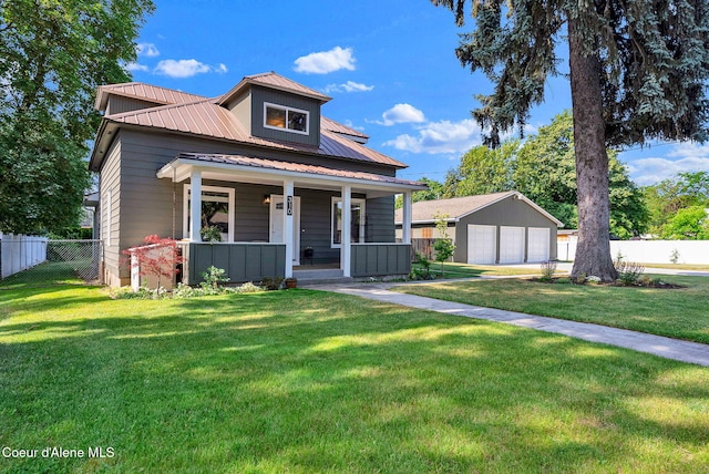 310 W Linden Ave, Coeur Dalene, ID 83814 - view of front of property featuring a porch, a garage, a metal roof, and an outdoor structure
