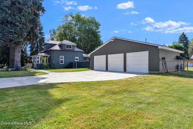 310 W Linden Ave, Coeur Dalene, ID 83814 - view of front of house with a garage, an outbuilding, a metal roof, and a standing seam roof