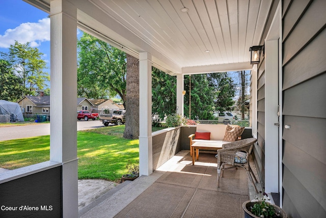 310 W Linden Ave, Coeur Dalene, ID 83814 - covered porch featuring a lawn and a residential view