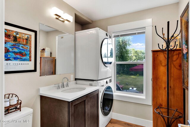310 W Linden Ave, Coeur Dalene, ID 83814 - washroom featuring stacked washer and clothes dryer and light wood finished floors