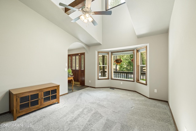 699 W Ranch Ct, Rathdrum, ID 83858 - spare room featuring carpet, arched walkways, high vaulted ceiling, and a ceiling fan