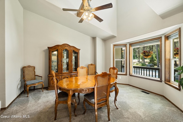 699 W Ranch Ct, Rathdrum, ID 83858 - dining room with light colored carpet, ceiling fan, and high vaulted ceiling