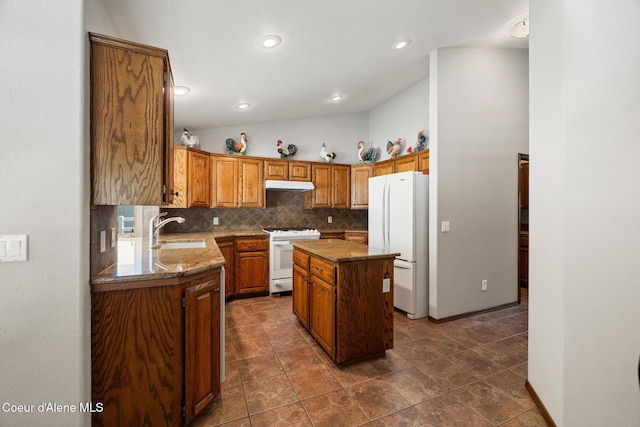 699 W Ranch Ct, Rathdrum, ID 83858 - kitchen featuring white appliances, under cabinet range hood, backsplash, a kitchen island, and light stone countertops